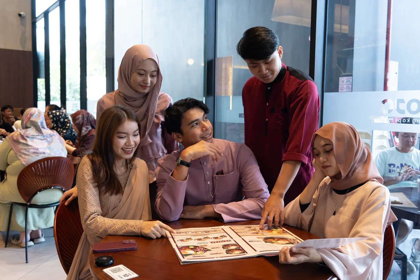 Friends choosing from the DOJO menu together at a table