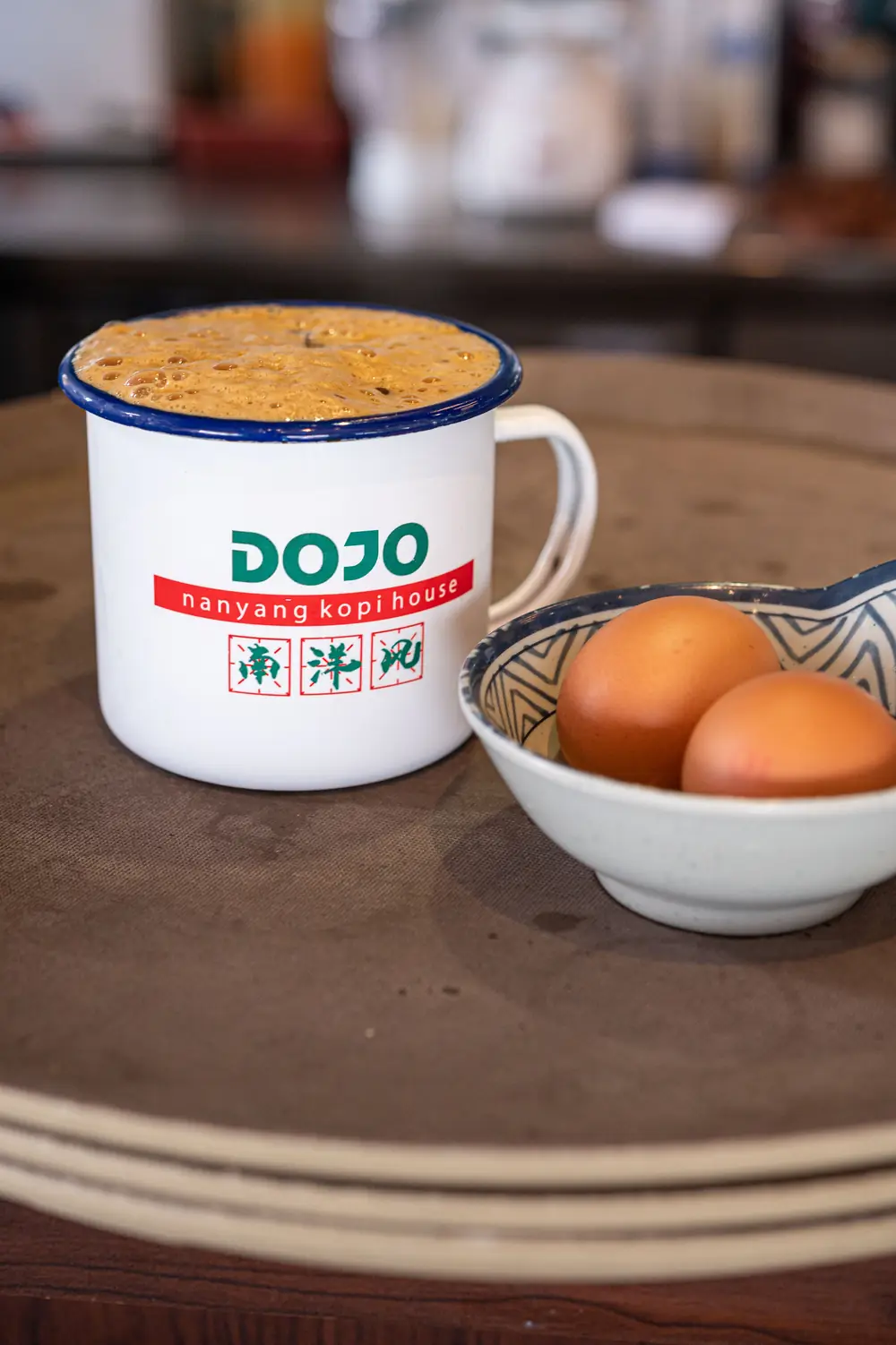 Frothy kopi in a DOJO enamel mug