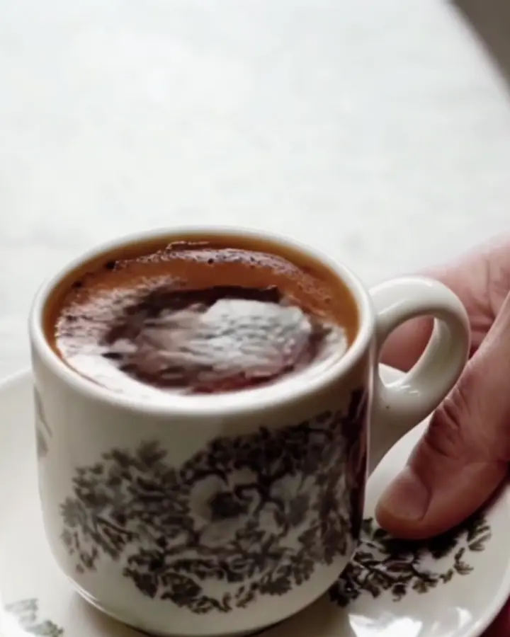 Black kopi in a traditional patterned cup